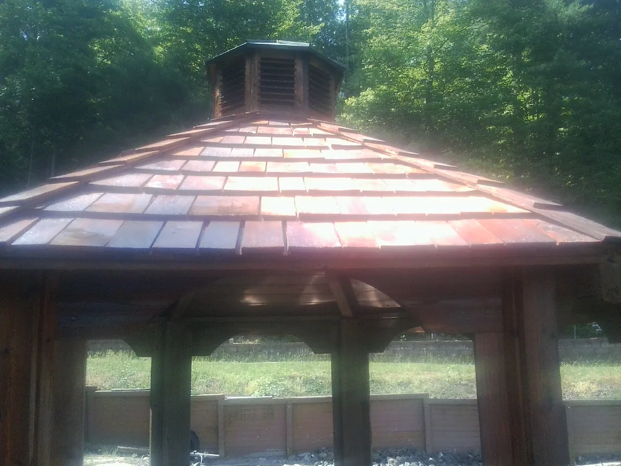New cedar shake roof and cupola on a lakeside gazebo in Newton Highlands